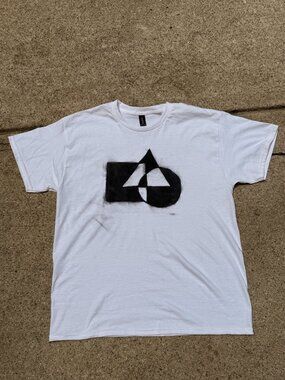 Spray painted design on a plain white shirt.